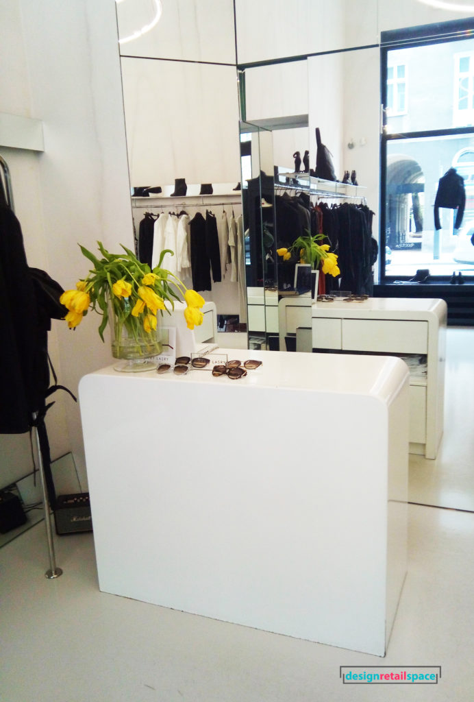 fashion boutique, monochrome space and white geometric cash desk