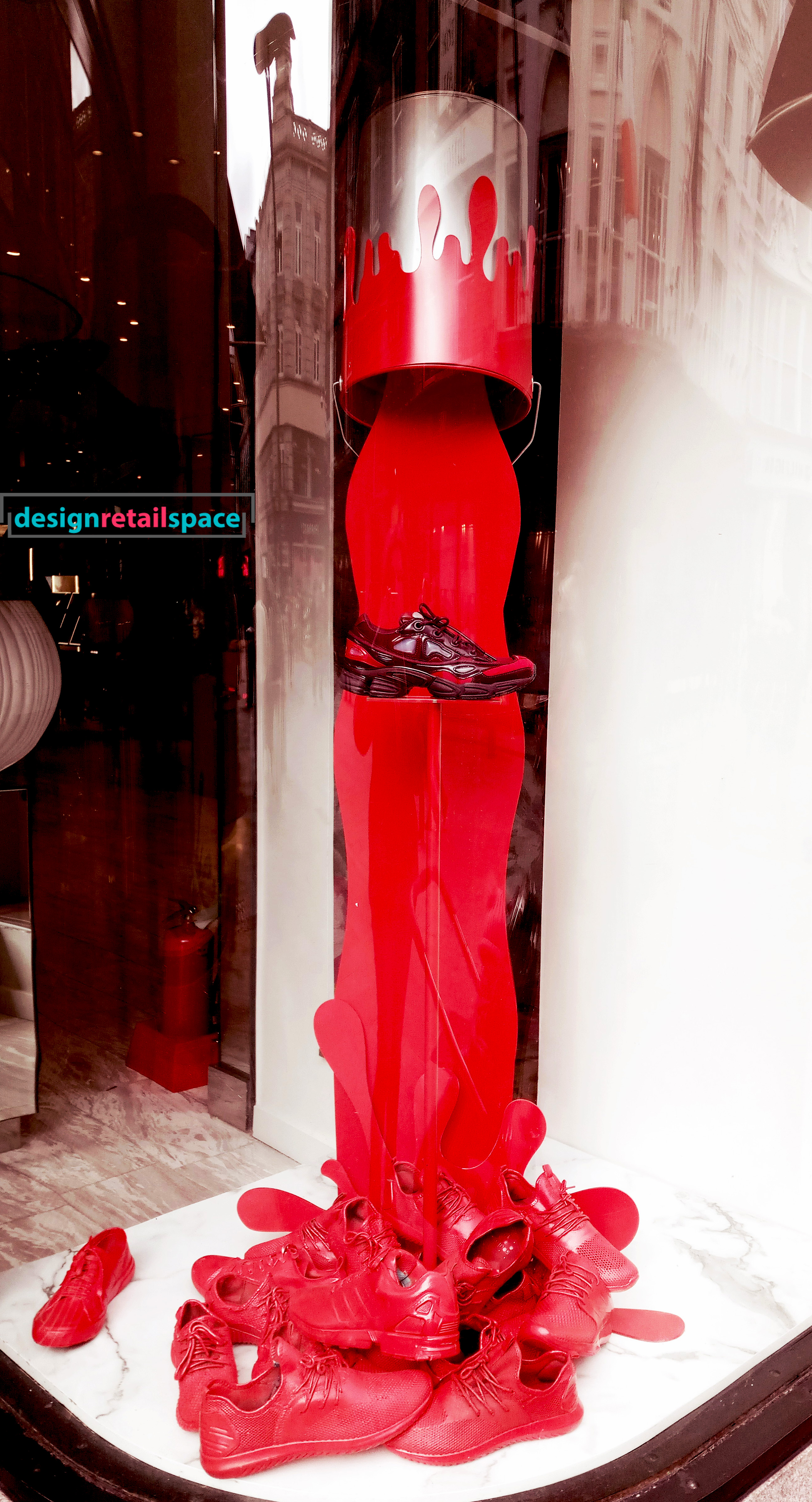 Brown Thomas Dublin window display showing bucket of red paint poured on shoes as representation of colour trends 2018