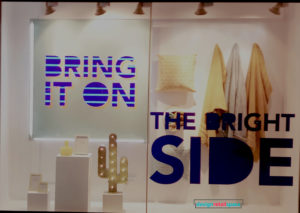 Debenhams window display with slogans 'Bring It on' and 'The Bright Side' 