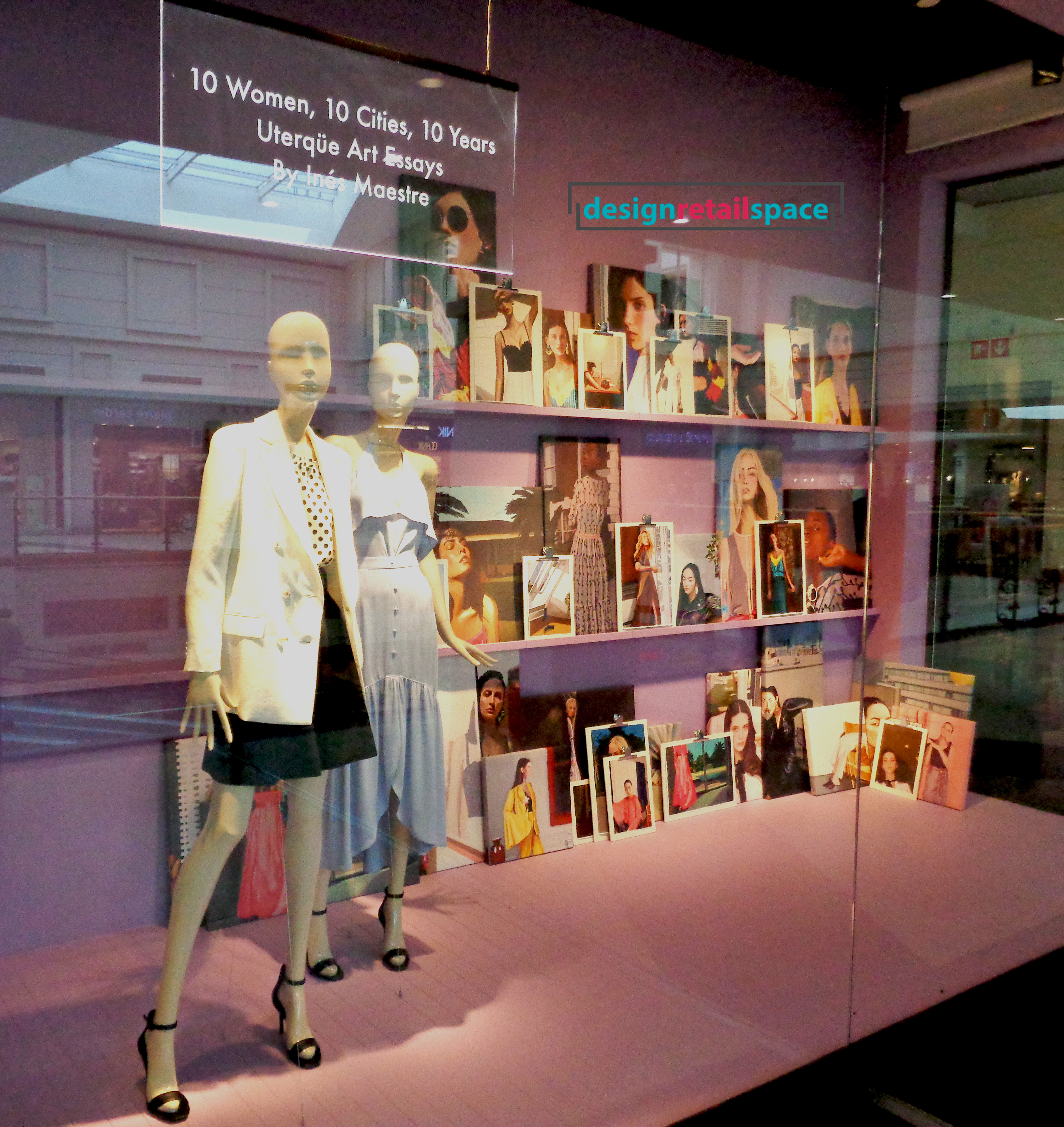 Uterque window display showing portraits of women against Millennial pink background