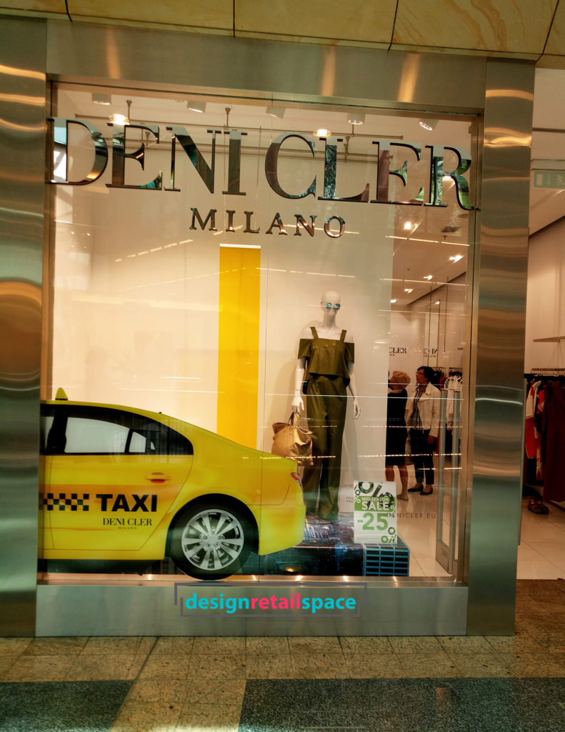 Deni Cler Milano window display with Yellow Cab, which is another way of expressing the yellow tones called the Gen Z yellow