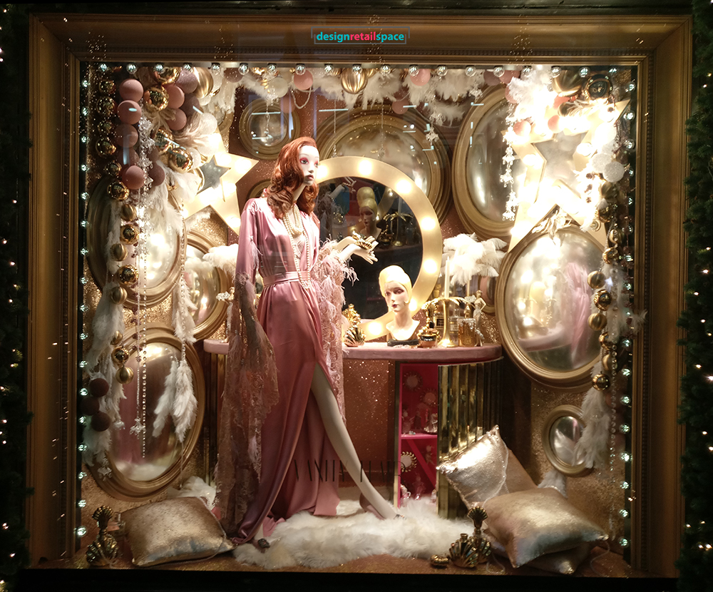 Brown Thomas Dublin Christmas 2018 window display with woman in a pink dress in a garderobe
